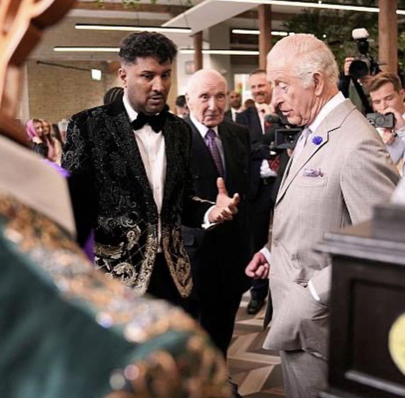 Imran Khan speaking with King Charles III while wearing an embroidered formal jacket