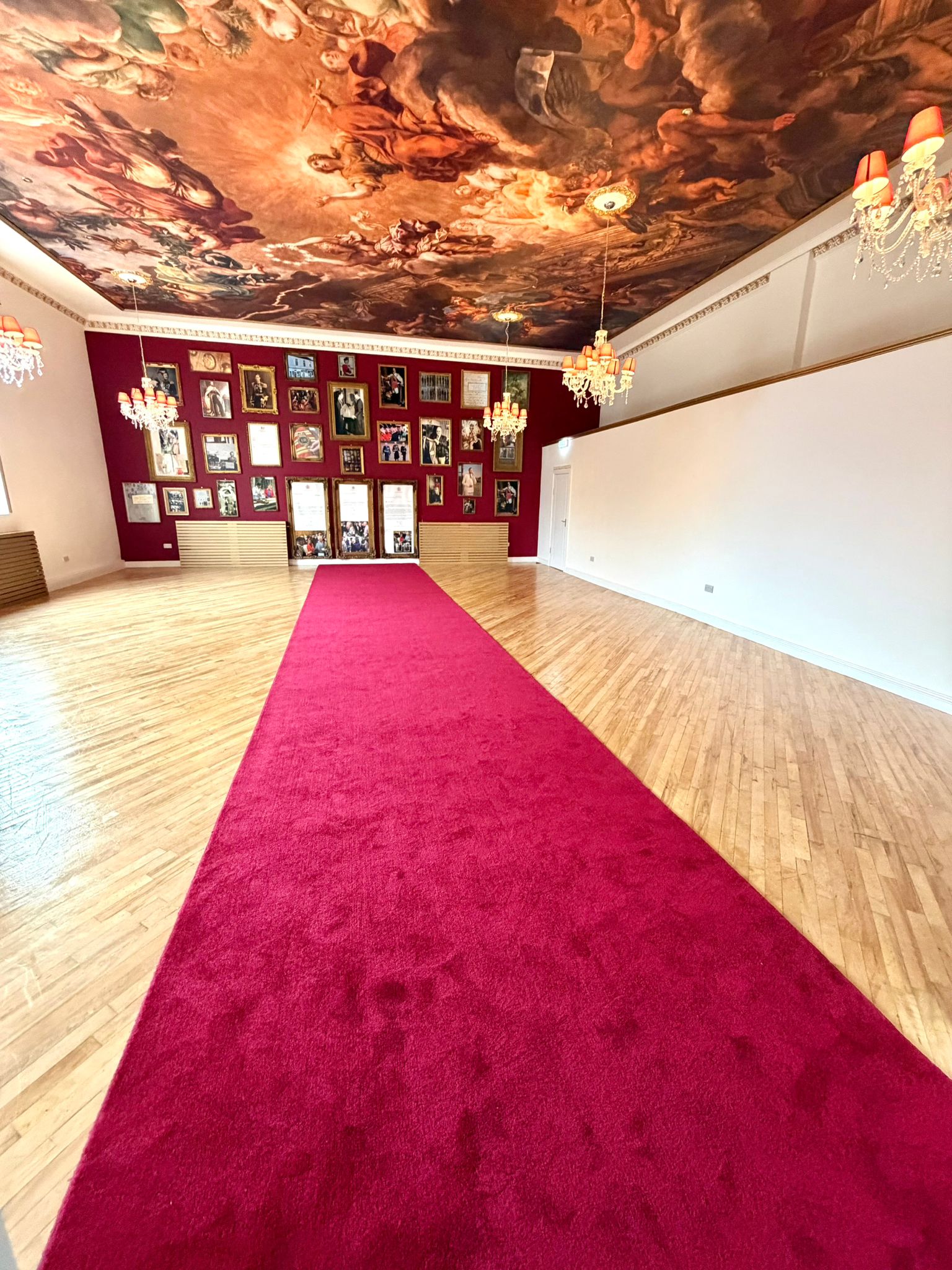Red carpet and painted ceiling inside Royal Harmony Ballroom