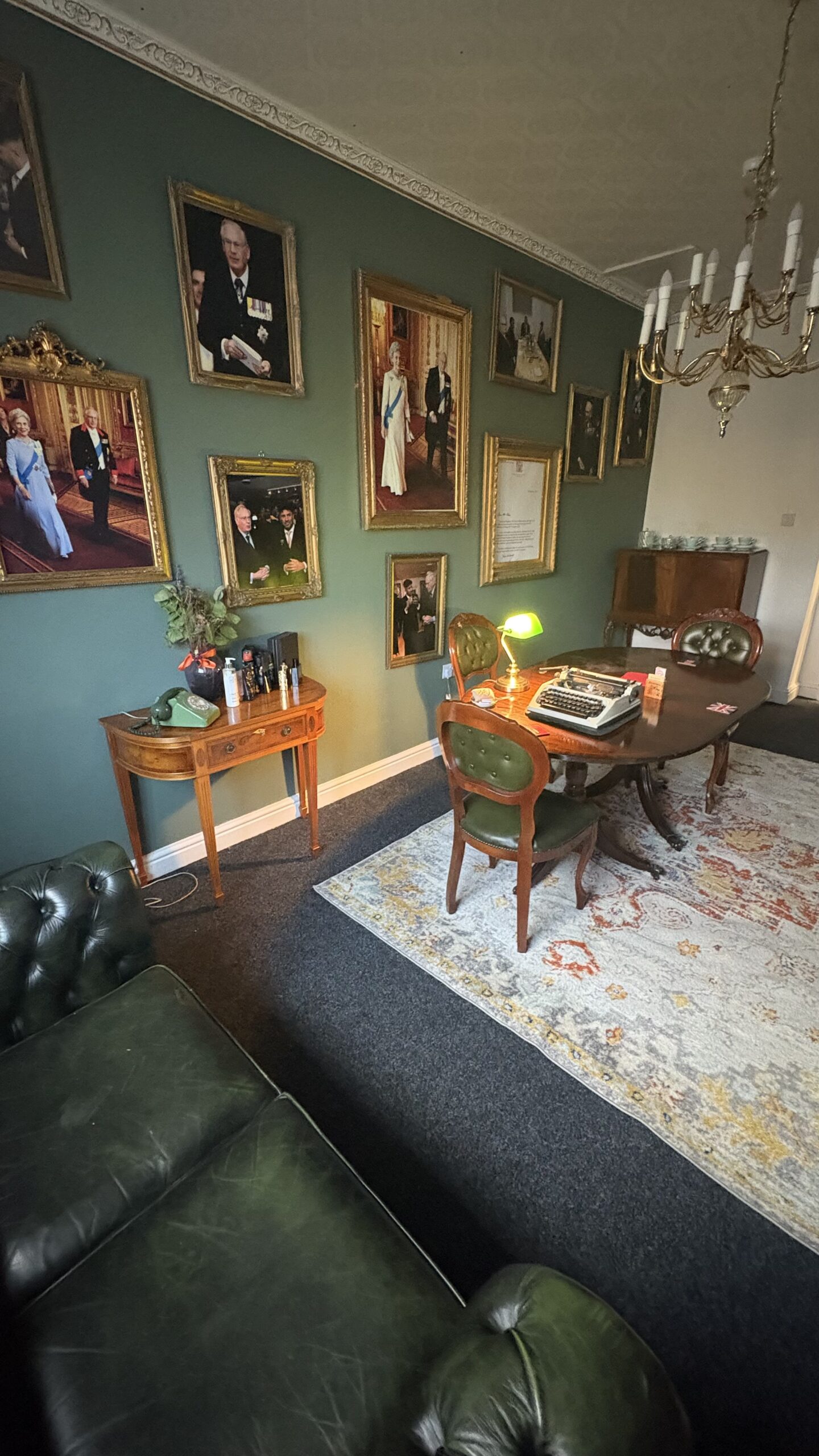 Desk, armchair and framed portraits inside the Duke of Gloucester Library