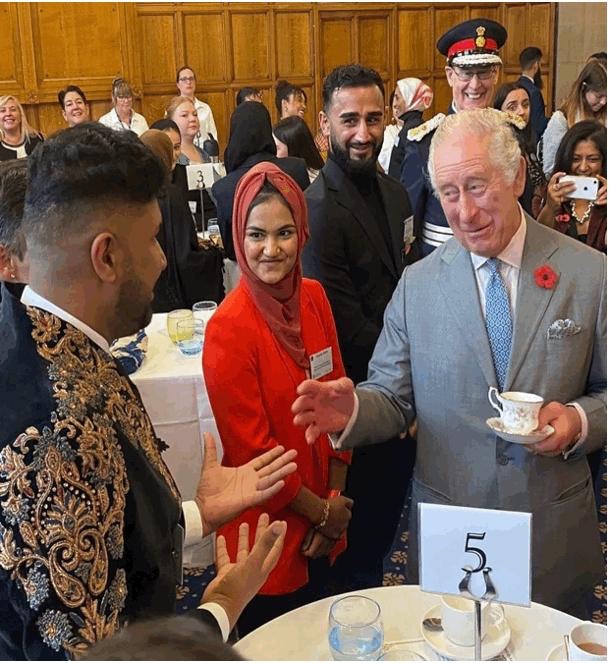 King Charles III speaking with Imran Khan at a Bradford event