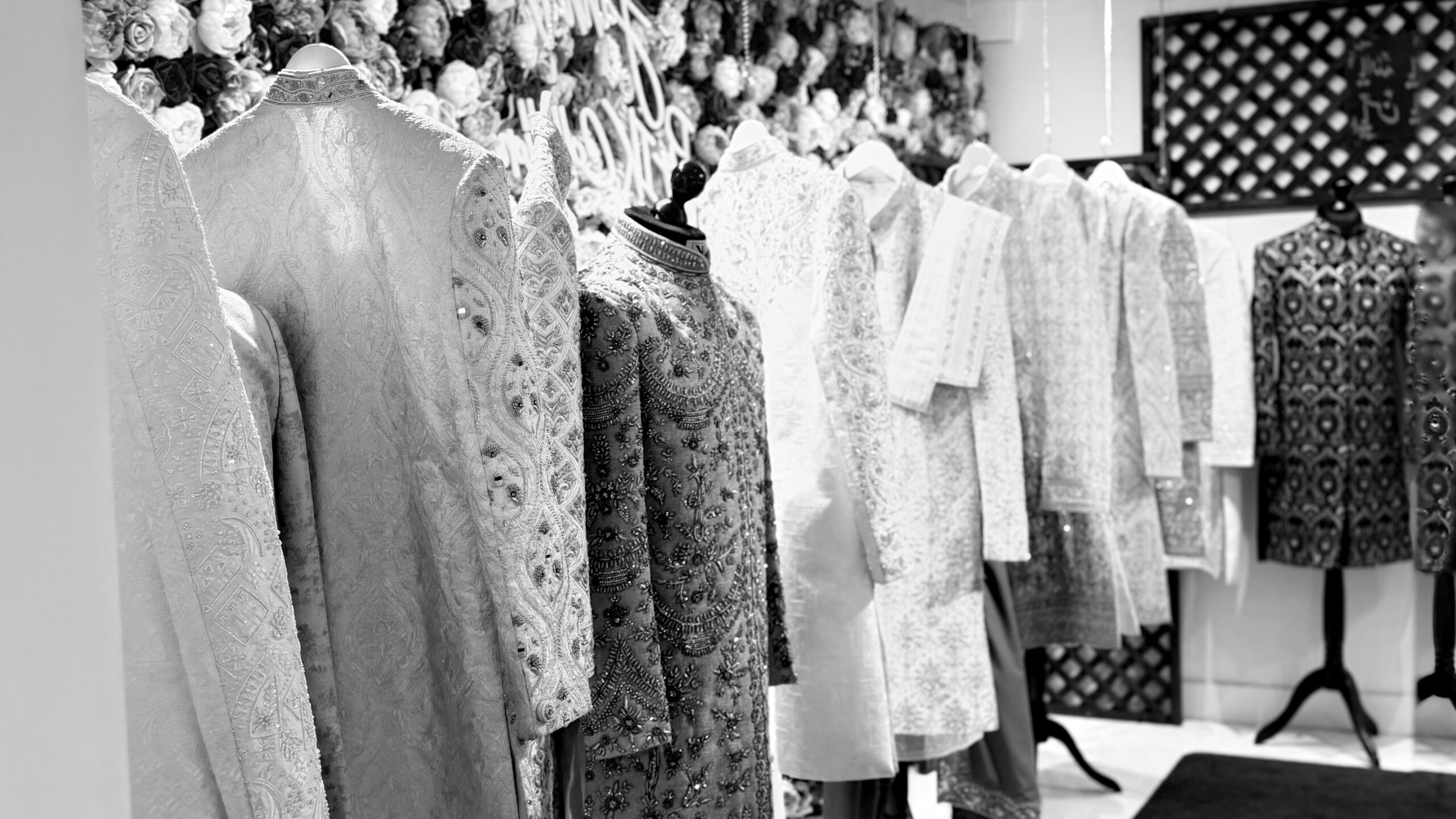 Embroidered sherwanis and prince coats displayed in the IK Collection showroom